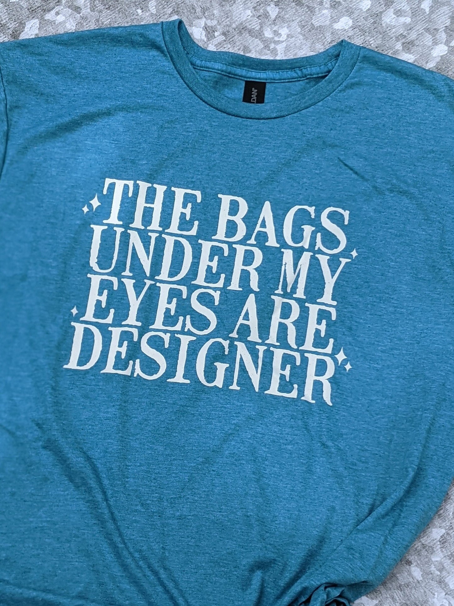 The bags under my eyes are designer t-shirt/designer t-shirt/snarky/sassy/funny/unisex shirt/funny gift/soft feel t-shirt